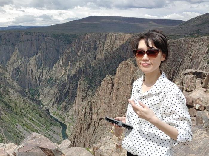 Hyunjung Lee on top of a mountain.